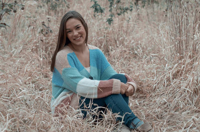 Portrait of a smiling young woman sitting outdoors