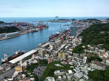 High angle view of townscape by sea against sky