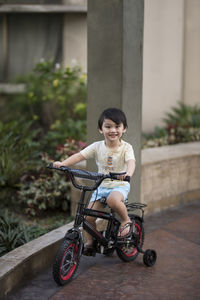 Portrait of cute boy riding bicycle