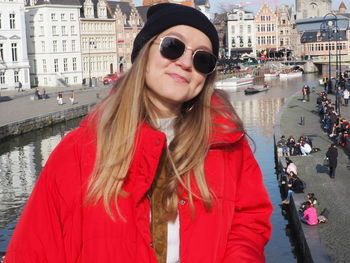 Portrait of smiling young woman in city