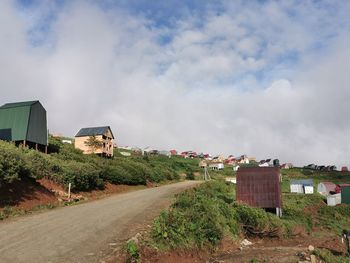 Road by city against sky