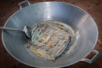 Close-up of fish being fried in pan