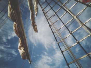 Low angle view of rope hanging on pole against sky