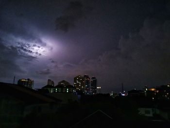 Low angle view of illuminated buildings in city at night
