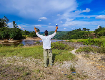 Man enjoying dramatic sky view at evening from flat angle shot is taken at meghalaya.