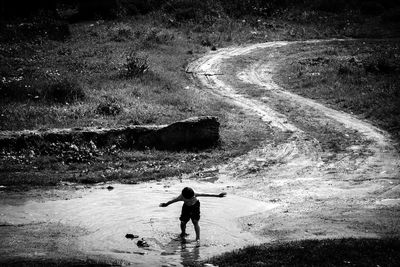 Rear view of man standing in water