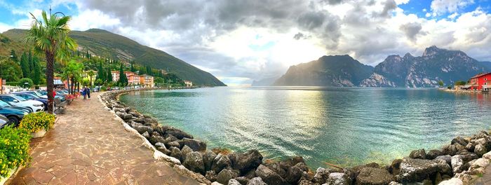 Panoramic view of people on beach against sky