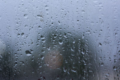 Full frame shot of raindrops on glass window