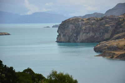 Scenic view of sea and mountains against sky