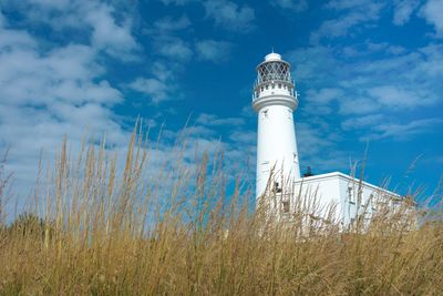 Lighthouse against cloudy sky