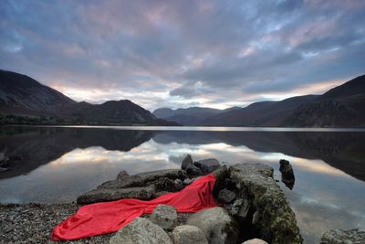 Scenic view of lake against cloudy sky