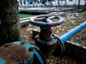 Close-up of rusty metal chain on field