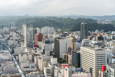 High angle view of buildings in city against sky