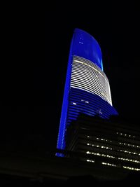 Low angle view of illuminated skyscraper
