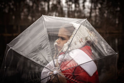 Midsection of woman holding umbrella