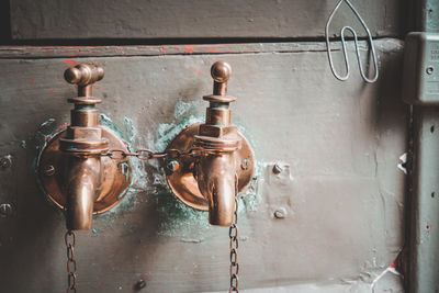Close-up of old pipe hanging on wall