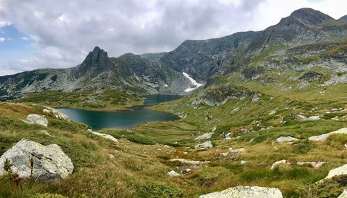 Scenic view of lake and mountains against sky