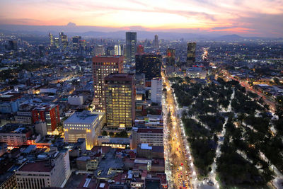 High angle view of illuminated city buildings against sky