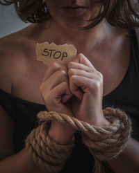 Close-up of woman holding rope