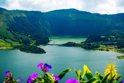 Scenic view of lake and mountains against sky