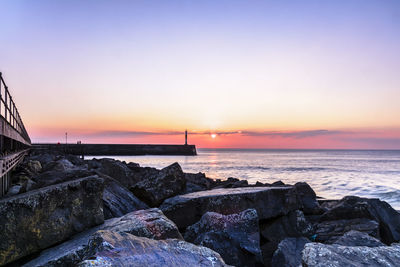 Scenic view of sea against clear sky during sunset