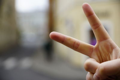 Cropped of person gesturing peace sign