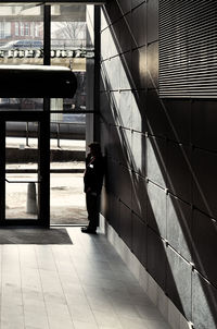 Rear view of man walking in building