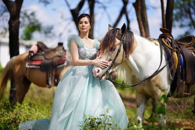 Portrait of young woman riding horse