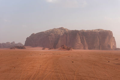 Rock formations at desert against sky