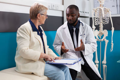 Male doctor explaining medical report to patient