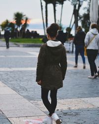 Rear view of woman walking on street