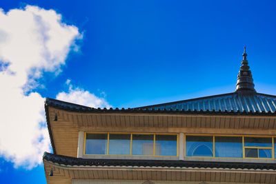 Low angle view of building against blue sky