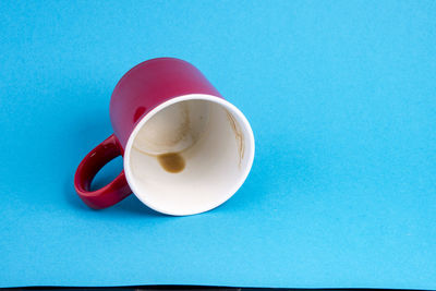 Close-up of coffee cup against blue background