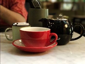 Close-up of coffee cup on table at home