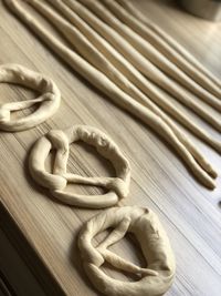 Dough for making pretzels at home in the kitchen. forming the dough while baking.