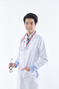 Portrait of smiling man standing against white background