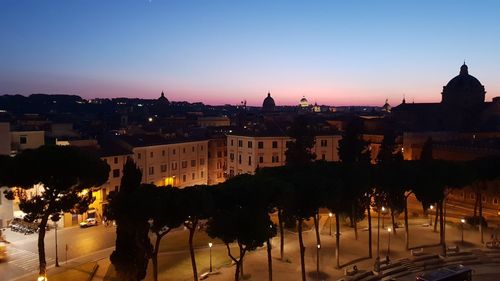 High angle view of illuminated buildings against sky at sunset