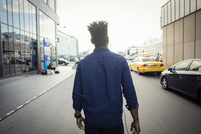 Rear view of man walking in city