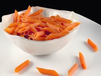 High angle view of chopped vegetables in bowl against black background