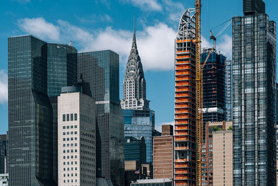 Panoramic view of buildings in city against sky