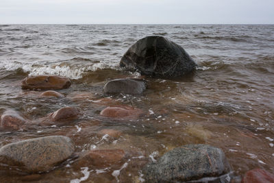 Rocks in sea against sky