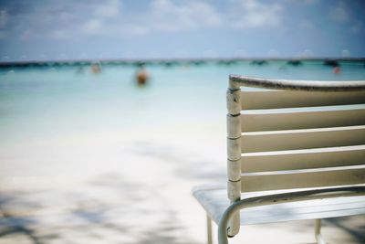 Close-up of empty chair at beach