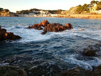 Rocks in sea against sky