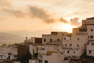 View of town against sky at sunset