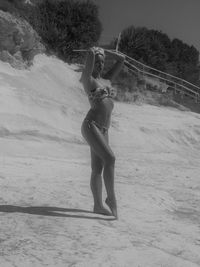 Full length of woman standing on beach