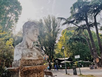 Statue against trees