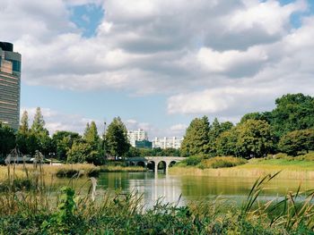 Scenic view of lake by buildings against sky