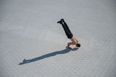 Man doing handstand on sunny day