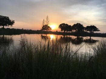 Scenic view of lake against sky during sunset