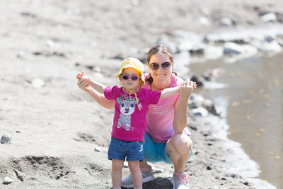 Full length of a girl wearing sunglasses on beach